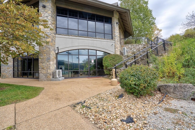 rear view of house featuring ac unit and a patio area