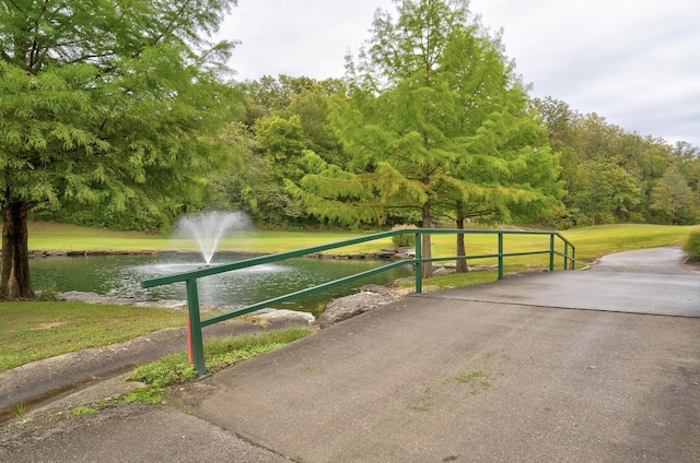 view of property's community featuring a yard and a water view