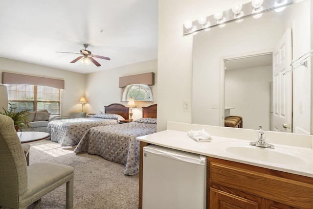 carpeted bedroom featuring sink and ceiling fan