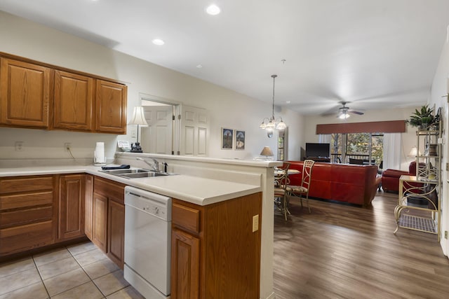 kitchen featuring light hardwood / wood-style flooring, kitchen peninsula, sink, and white dishwasher