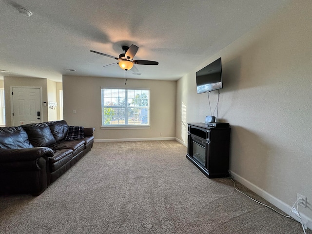 living room with a textured ceiling, carpet floors, and ceiling fan