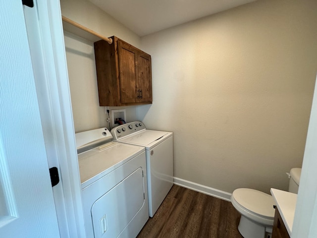 laundry area featuring washer and clothes dryer and dark hardwood / wood-style flooring