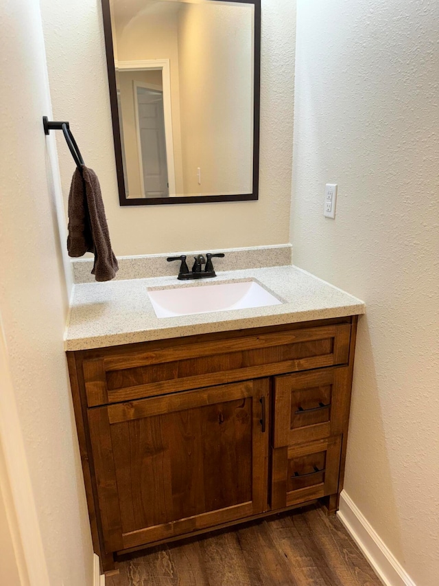 bathroom featuring vanity and wood-type flooring