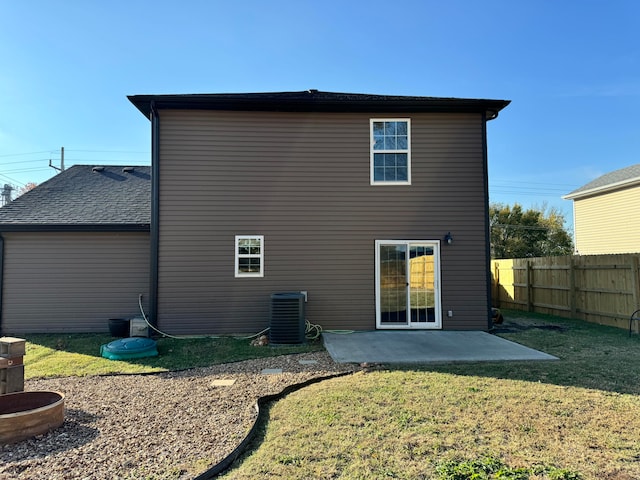 rear view of house with a yard, a patio area, and central AC unit