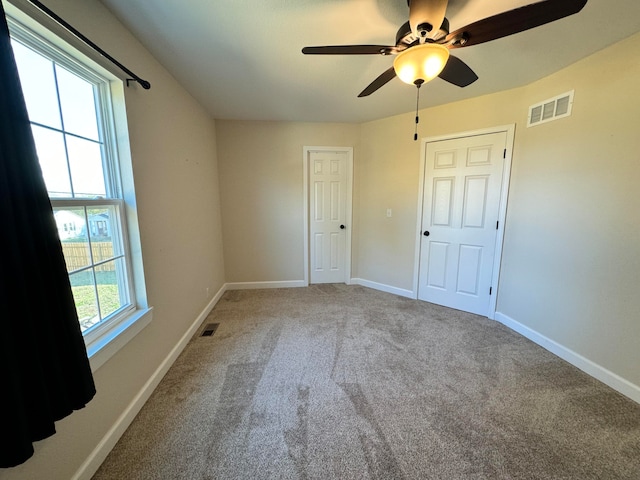 unfurnished bedroom with carpet flooring and ceiling fan