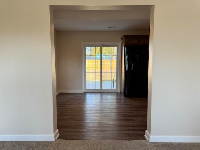 unfurnished room featuring dark wood-type flooring