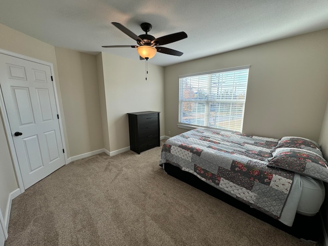 bedroom featuring light colored carpet and ceiling fan