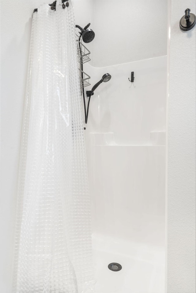 interior details featuring a shower with curtain