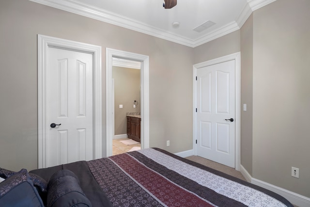 bedroom featuring light carpet, crown molding, ensuite bathroom, and ceiling fan