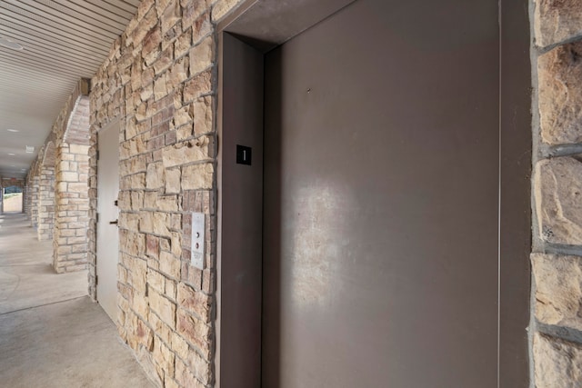 room details featuring elevator and concrete flooring