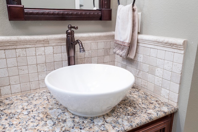 bathroom featuring tile walls and sink