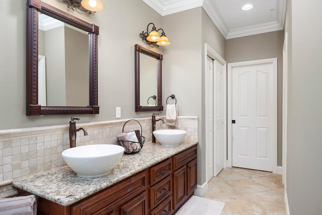 bathroom with vanity, ornamental molding, and tile patterned flooring