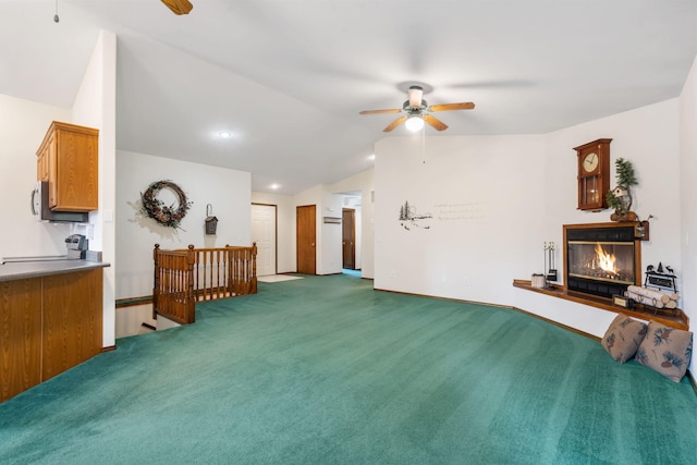 living room with lofted ceiling, carpet flooring, and ceiling fan