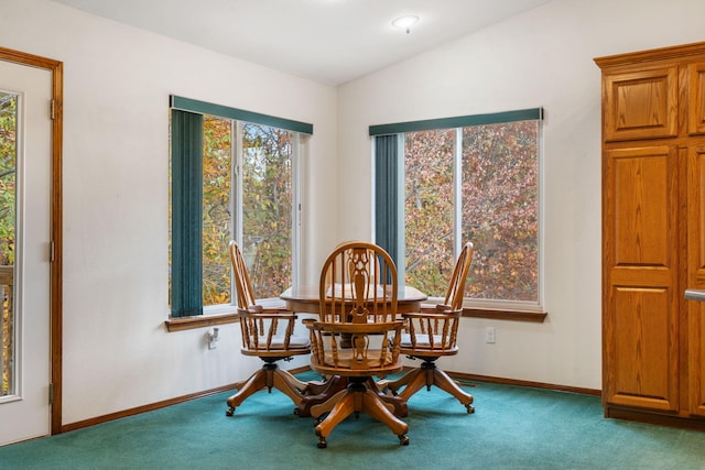 dining space featuring vaulted ceiling and carpet floors