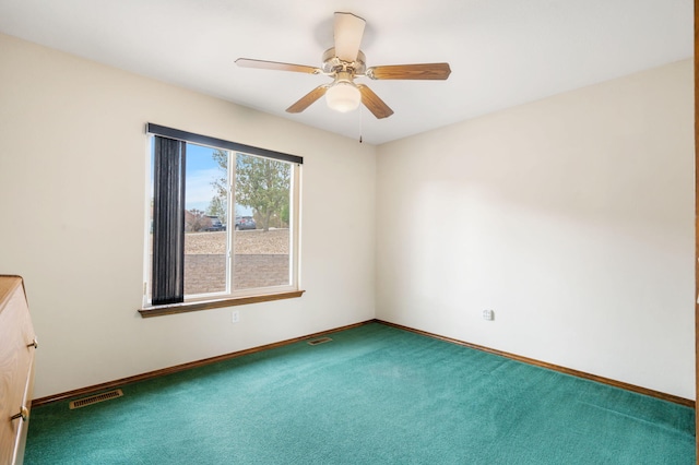 spare room featuring ceiling fan and carpet