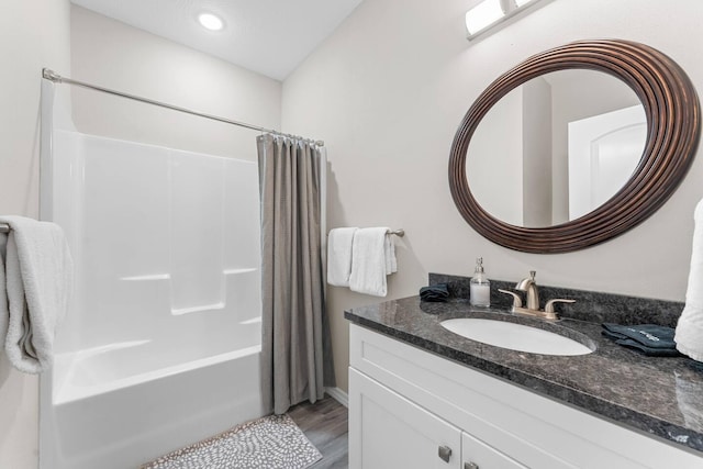 bathroom featuring vanity, shower / tub combo, and hardwood / wood-style flooring