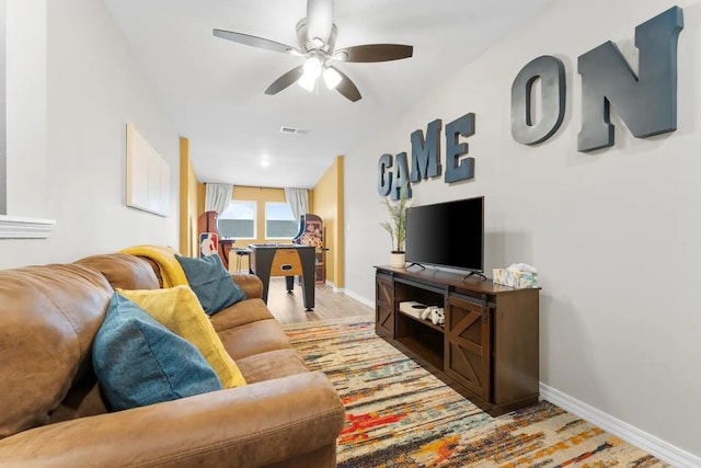 living room with ceiling fan and light hardwood / wood-style flooring