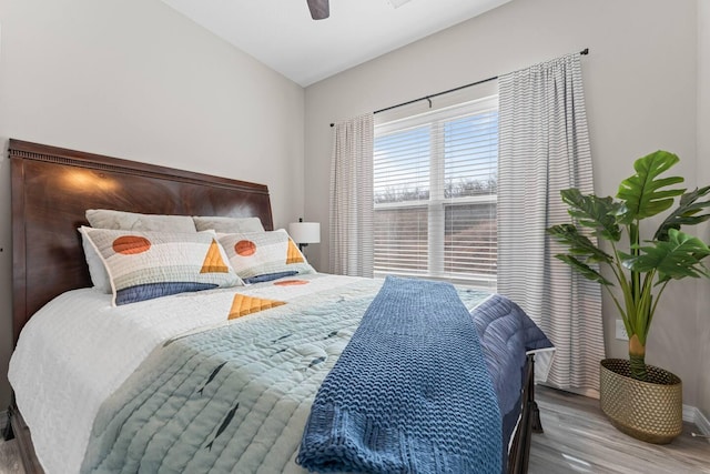 bedroom with ceiling fan, lofted ceiling, and hardwood / wood-style floors