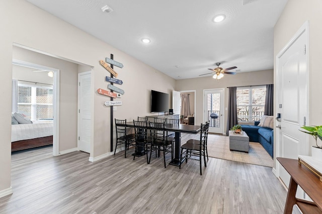 dining area with ceiling fan and hardwood / wood-style flooring