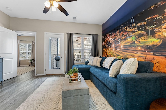 living room with ceiling fan and hardwood / wood-style flooring