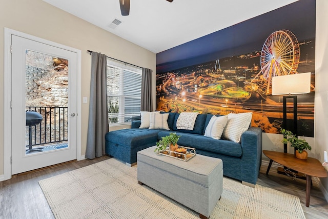 living room featuring ceiling fan and hardwood / wood-style floors