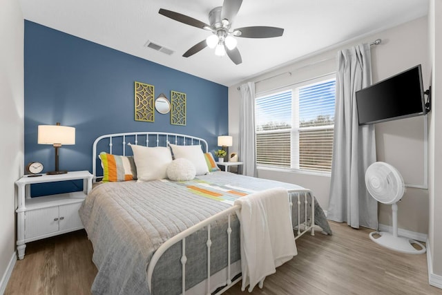 bedroom with ceiling fan and hardwood / wood-style flooring