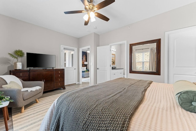 bedroom with light hardwood / wood-style floors, connected bathroom, and ceiling fan