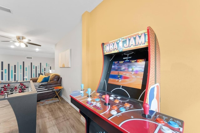 recreation room with ceiling fan and wood-type flooring