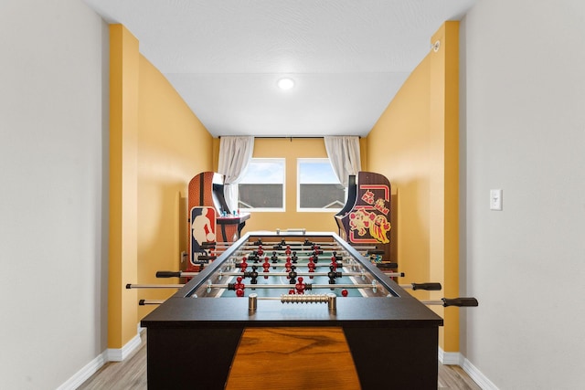 playroom featuring light hardwood / wood-style flooring and a textured ceiling