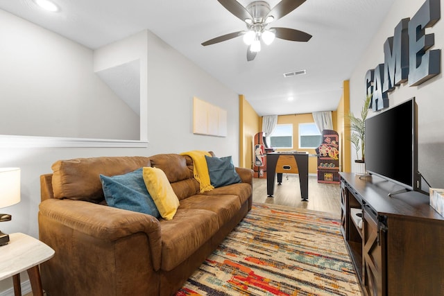 living room with light hardwood / wood-style flooring and ceiling fan