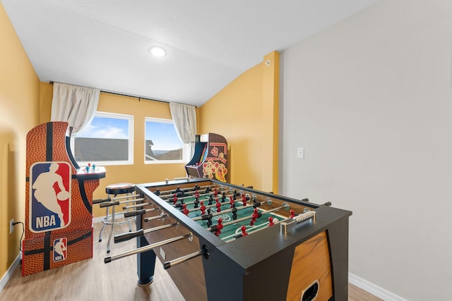 rec room featuring wood-type flooring and vaulted ceiling