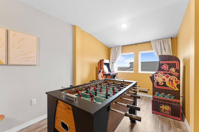 rec room featuring wood-type flooring and vaulted ceiling