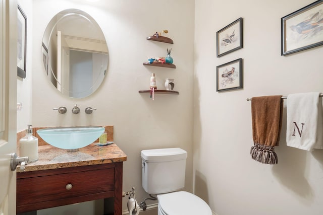 bathroom with toilet and vanity