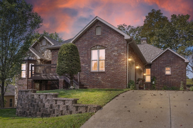 view of front of property featuring a yard and a deck