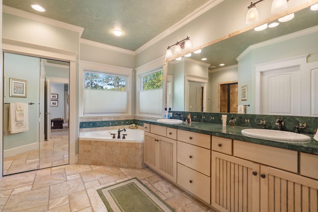 bathroom featuring vanity, ornamental molding, and tiled bath