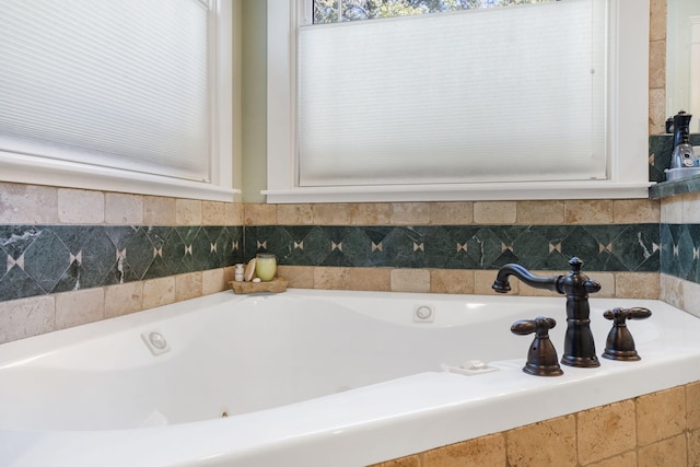 bathroom with a relaxing tiled tub