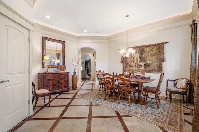 dining area with a chandelier and crown molding