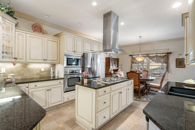 kitchen featuring appliances with stainless steel finishes, cream cabinetry, and island range hood