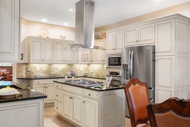 kitchen with island exhaust hood, light tile patterned floors, stainless steel appliances, crown molding, and a center island