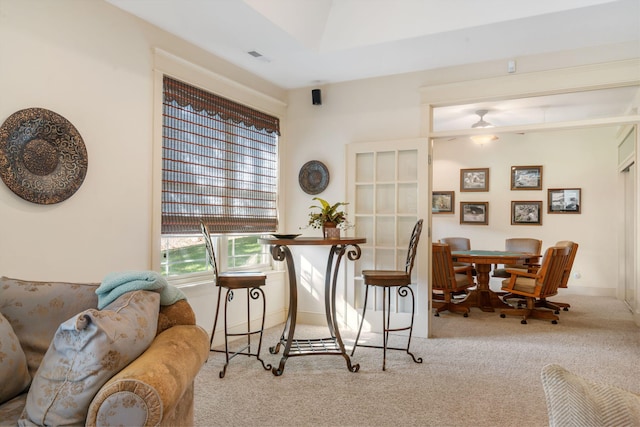 dining area with light carpet and ceiling fan