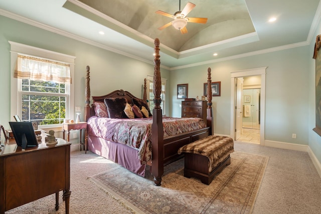 carpeted bedroom featuring ceiling fan, crown molding, vaulted ceiling, and a tray ceiling