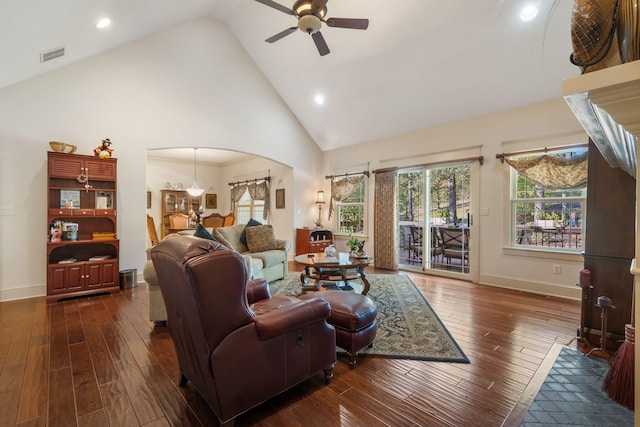 living room featuring dark wood-type flooring, ceiling fan, and high vaulted ceiling