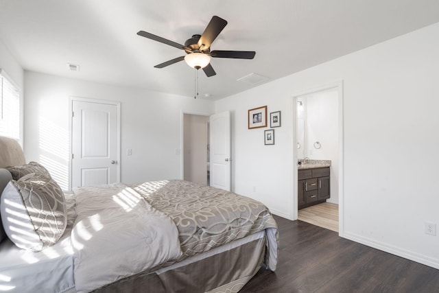 bedroom featuring dark wood-type flooring, ensuite bathroom, and ceiling fan