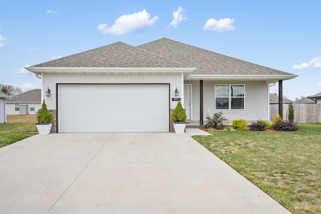 ranch-style home with a garage and a front lawn