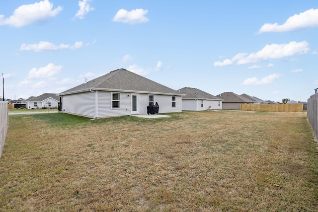 rear view of house featuring a patio area and a lawn