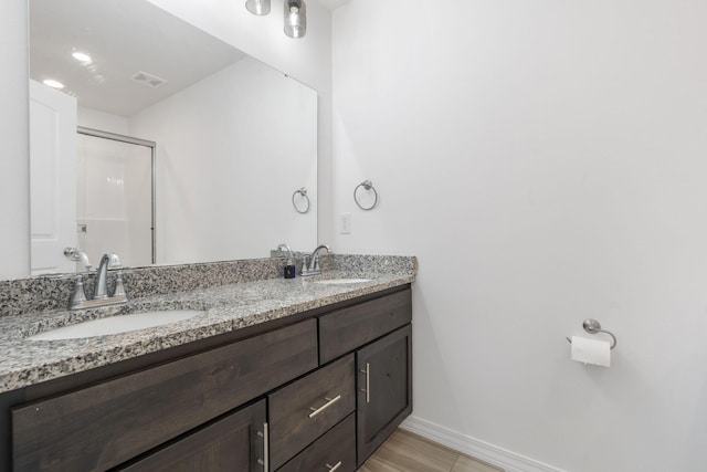 bathroom with vanity, hardwood / wood-style floors, and walk in shower