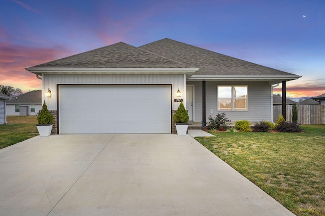 ranch-style house featuring a yard and a garage