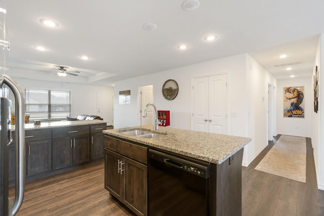 kitchen with black dishwasher, sink, light stone counters, dark hardwood / wood-style floors, and a kitchen island with sink