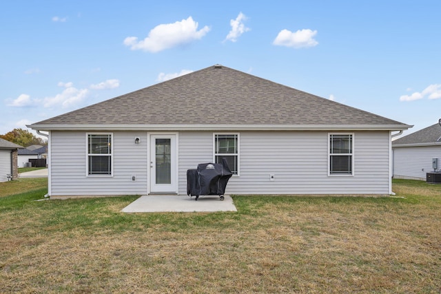 back of house featuring a patio and a yard