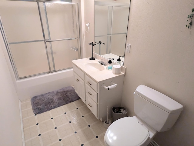 full bathroom with vanity, combined bath / shower with glass door, and toilet